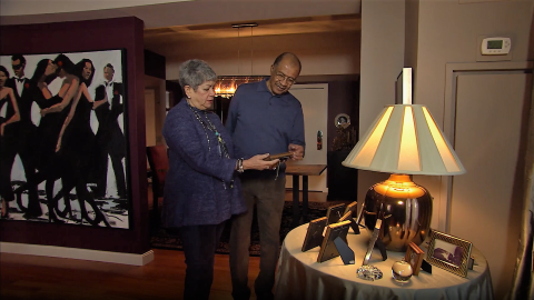 Jacqui and Wayne Budd at home with family photos